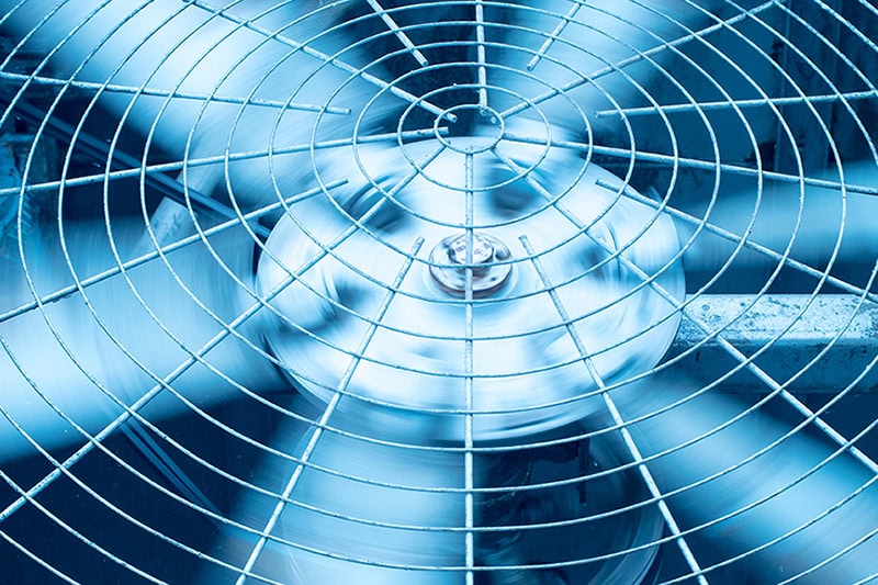 3 Tips to Prevent AC Breakdown During a Heat Wave. Close up photo of the top of an HVAC unit.